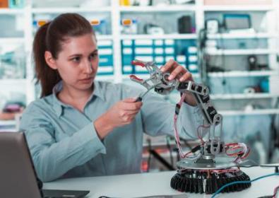 Woman working on robotic arm