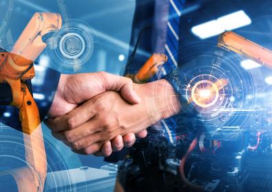 A handshake between two men in business suits, surrounded by semi-transparent images of manufacturing equipment